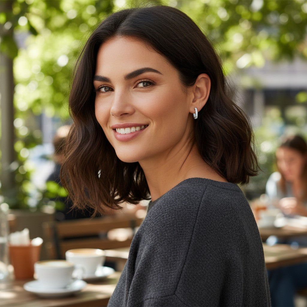Bee-Bees 3mm D color moissanite full hoop earrings in S925 silver worn by a smiling woman in a cafe setting
