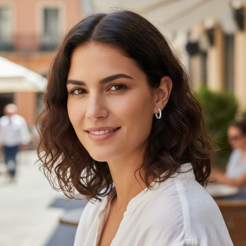 Bee-Bees 1.5mm D color moissanite hoop earrings in S925 sterling silver worn by a woman in a casual outdoor setting.
