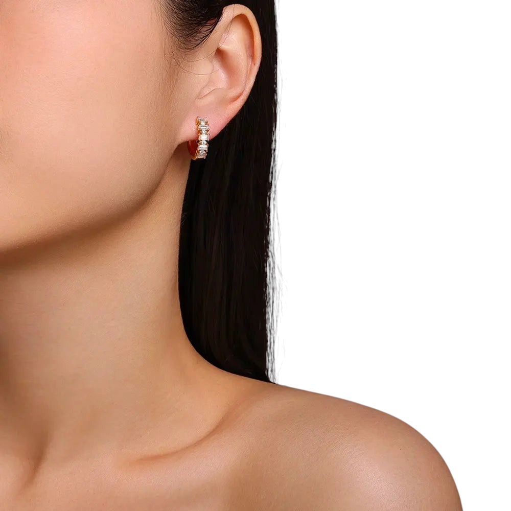 Bee-Bees 18K gold plated sterling silver huggie earrings featuring emerald and round cut moissanite stones on a model
