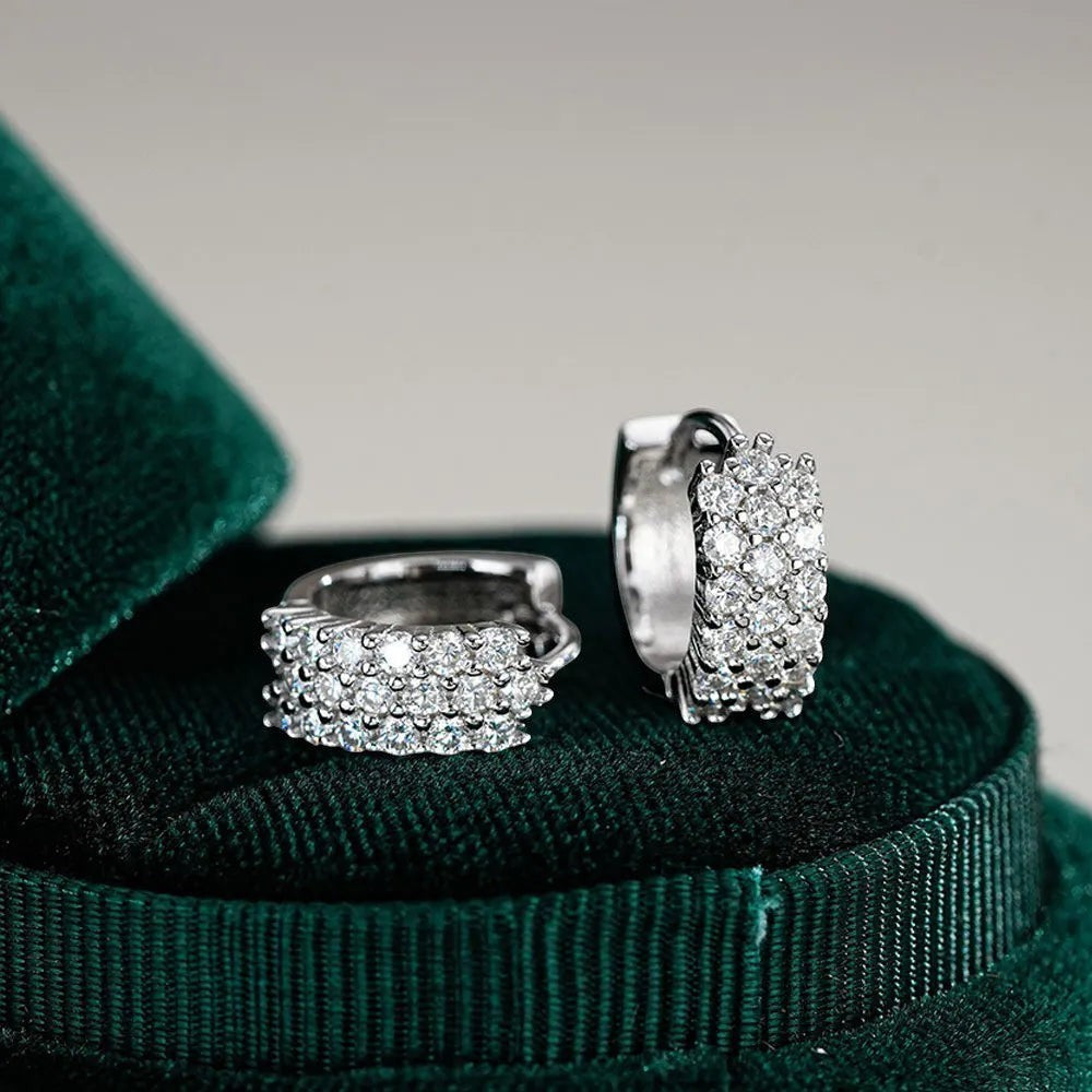 Bee-Bees D Color VVS1 Moissanite huggie hoop earrings in 925 sterling silver with 18K white gold plating.