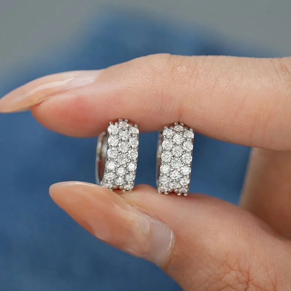 Bee-Bees D Color VVS1 Moissanite huggie hoop earrings in 925 sterling silver with 18K white gold plating.