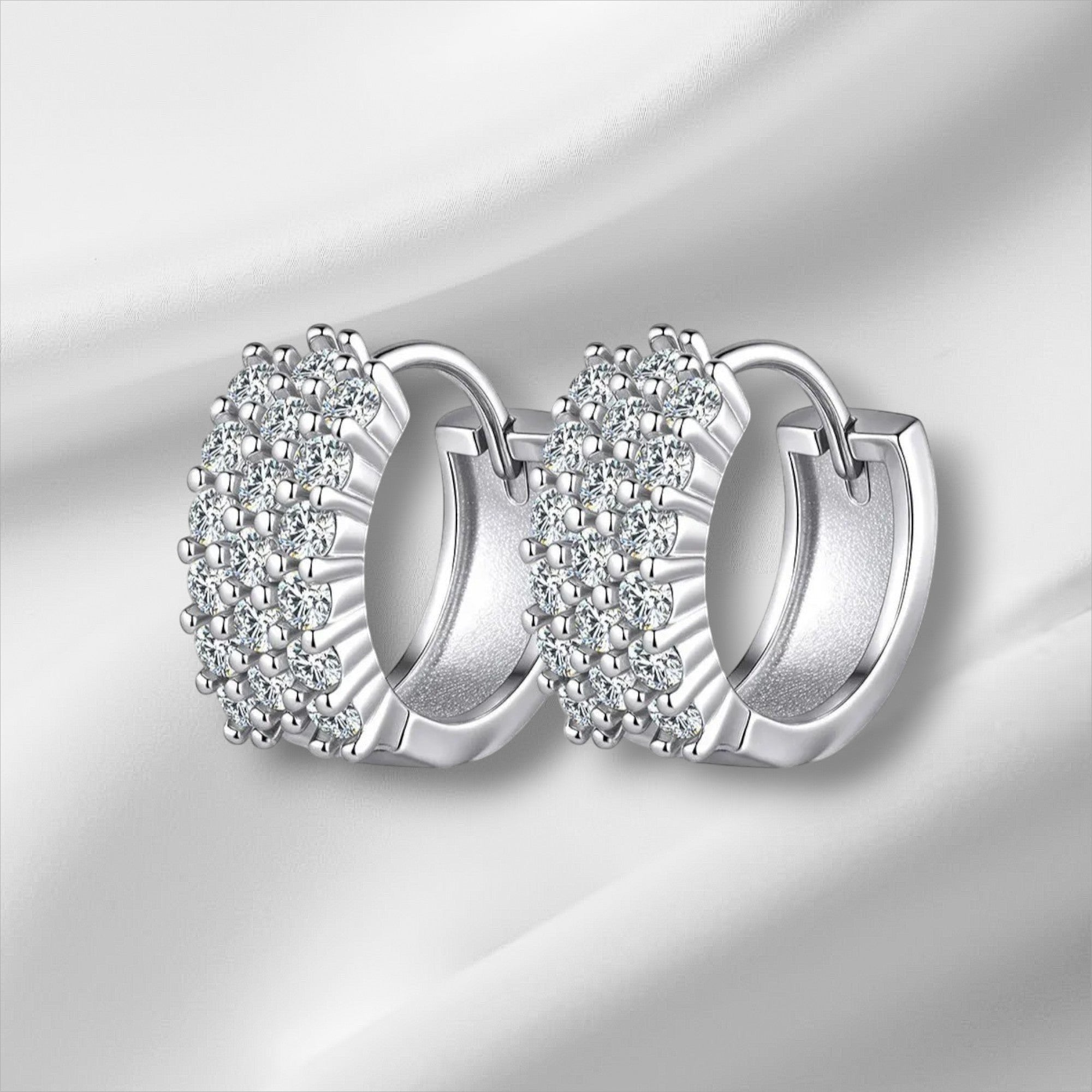 Bee-Bees D Color VVS1 Moissanite Huggie Hoop Earrings in 925 Sterling Silver with 18K White Gold plating.