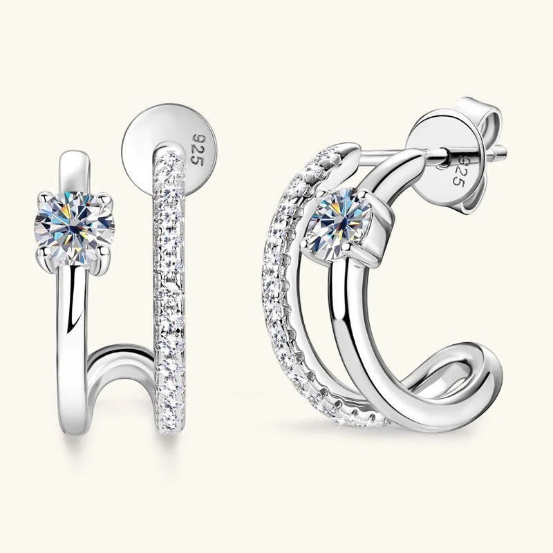 Bee-Bee's sterling silver huggie hoop earrings with D color VVS1 moissanite stones, pave-set on the outer hoop.