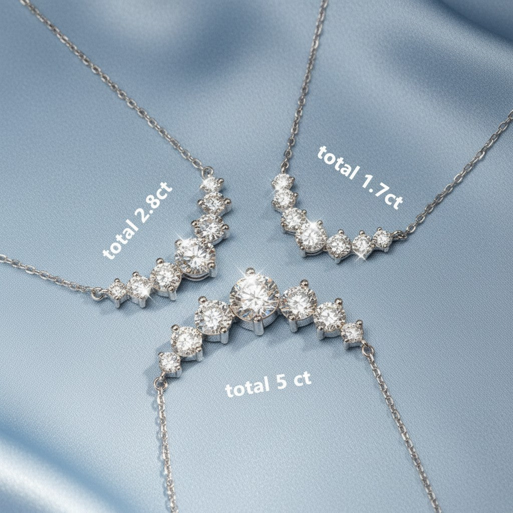 Bee-Bee's sterling silver necklace with a curve of sparkling moissanite stones in 1.7ct, 2.8ct, and 5ct total weights.
