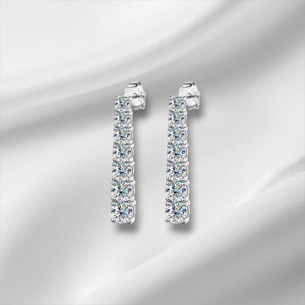 Bee-Bee's D VVS1 Moissanite pendant earrings in 18K white gold plated sterling silver. 2.5cm drop with 14 stones.