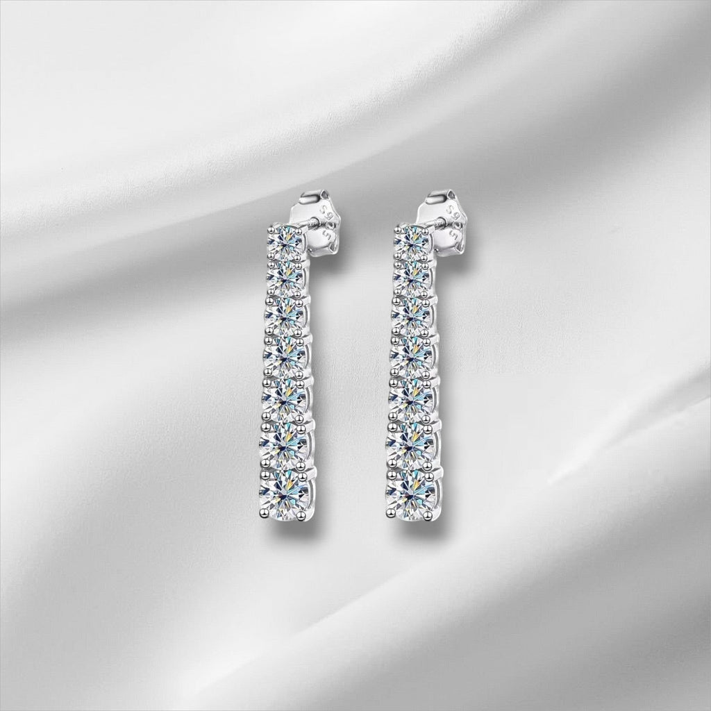 Bee-Bee's D VVS1 Moissanite pendant earrings in 18K white gold plated sterling silver. 2.5cm drop with 14 stones.