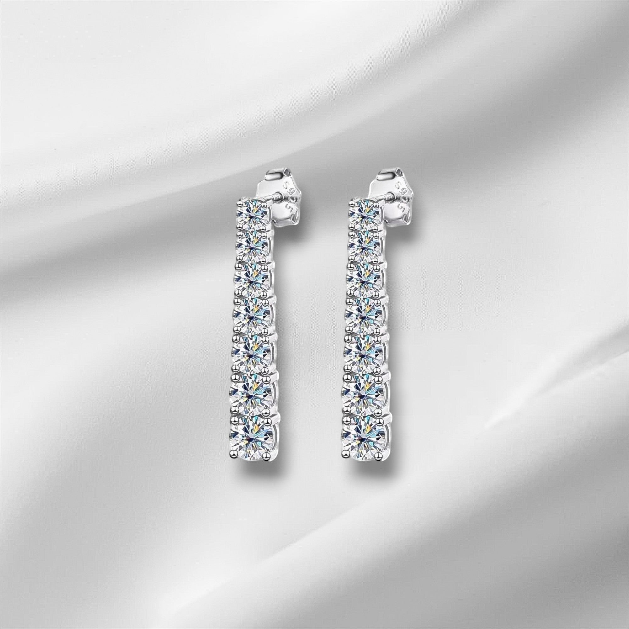 Bee-Bee's D VVS1 Moissanite pendant earrings in 18K white gold plated sterling silver. 2.5cm drop with 14 stones.