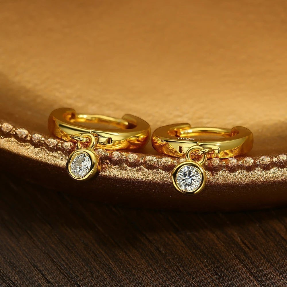 Bee-Bee's gold plated sterling silver hoop earrings with dangling moissanite pendants. D color VVS1 stones.