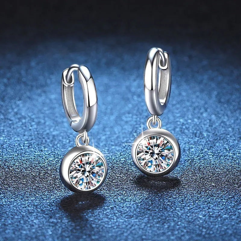 Bee-Bee's sterling silver hoop earrings with a dangling round-cut moissanite pendant, D color VVS1 clarity.