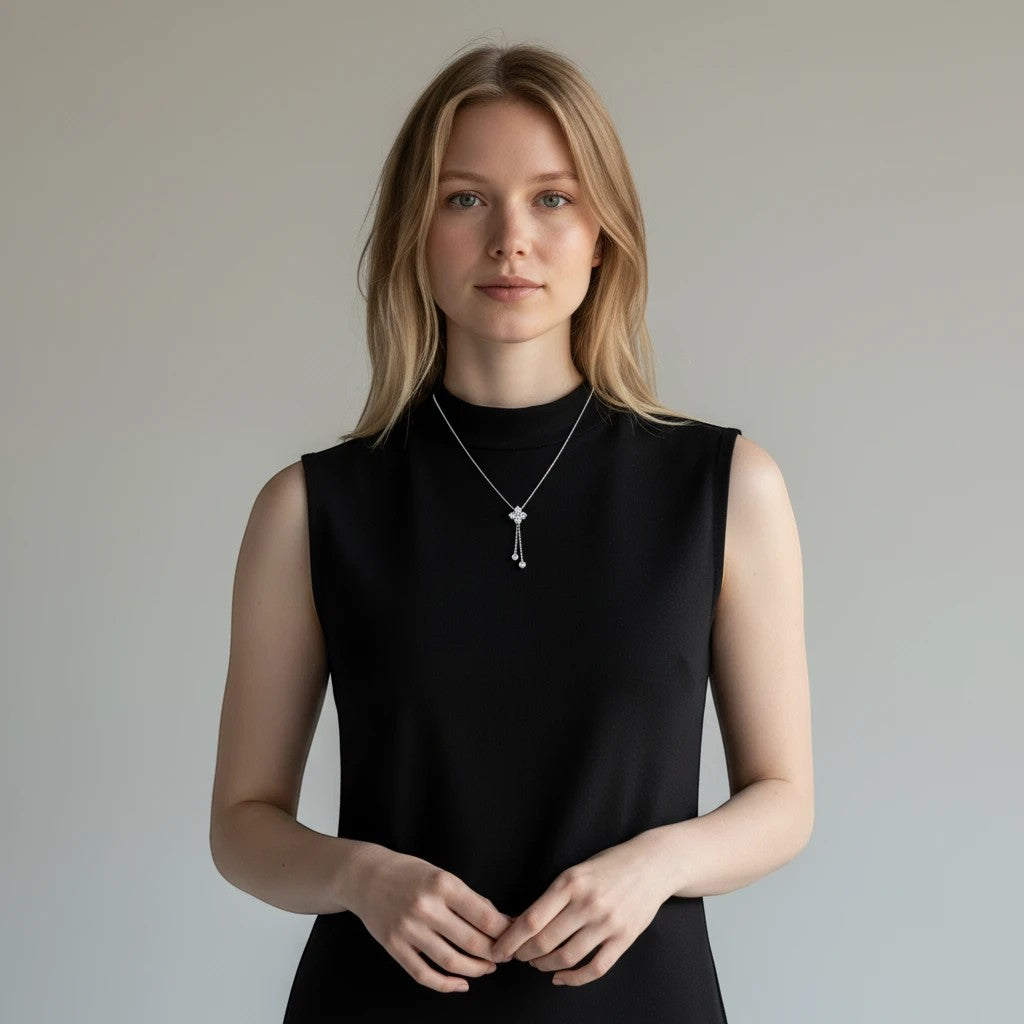 Bee-Bees dainty 4mm moissanite pendant necklace in s925 sterling silver worn by a woman in a black sleeveless top