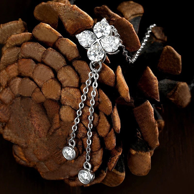 Bee-Bees dainty sterling silver necklace featuring a sparkling moissanite flower pendant with dangling stone accents.