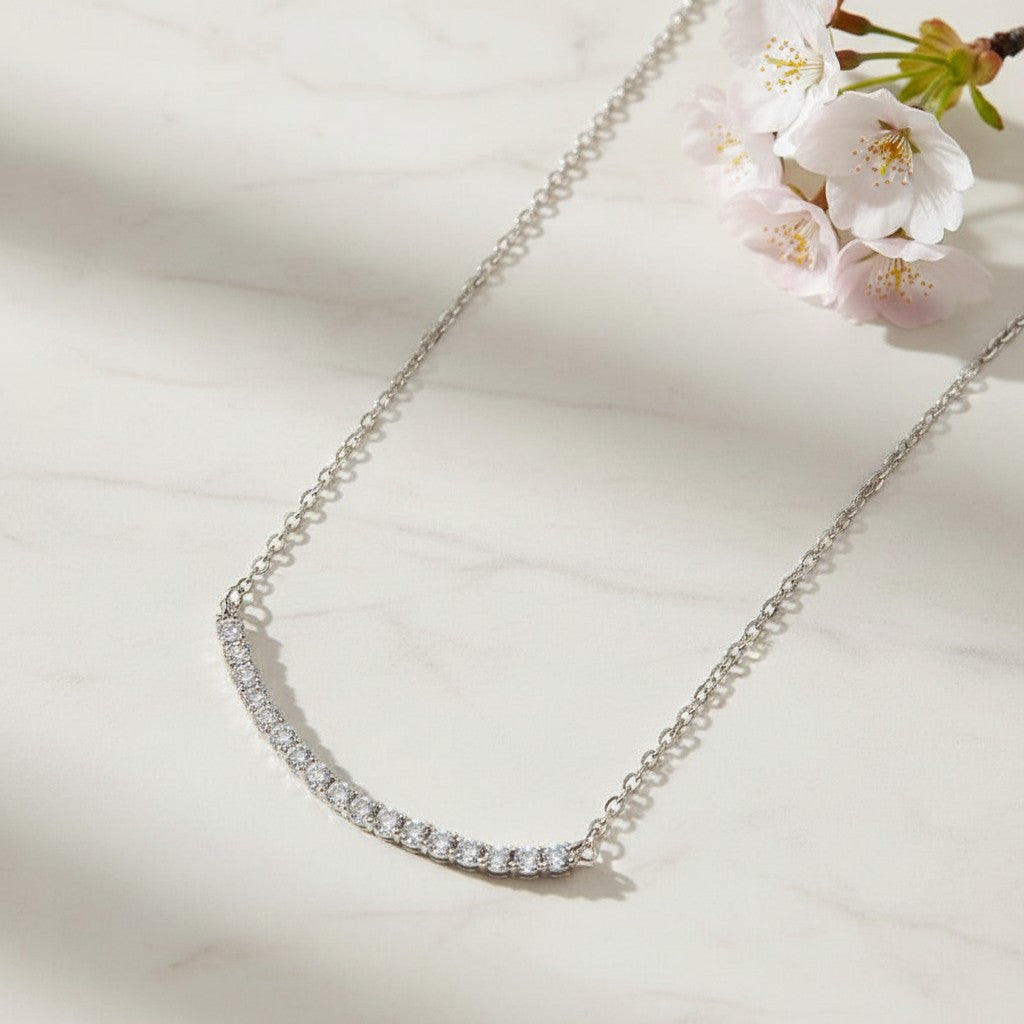 Bee-Bees 18k gold plated s925 sterling silver necklace with D VVS1 Moissanite stones in a curved smile design.