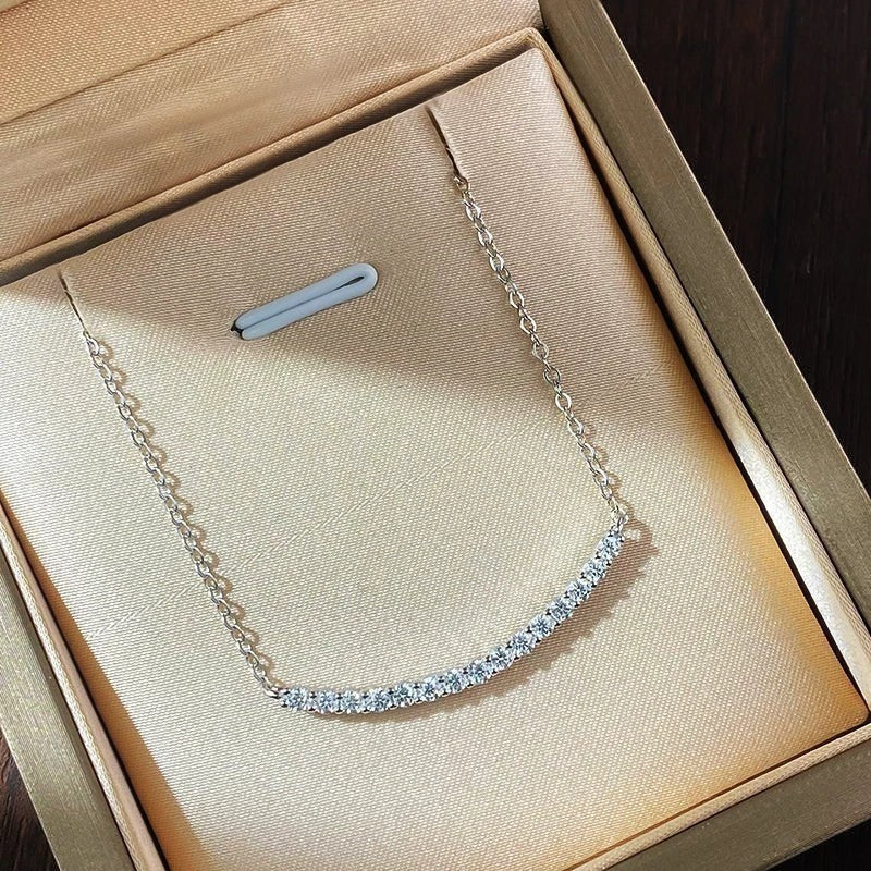 Bee-Bees 18k gold plated sterling silver necklace with a curved row of D VVS1 Moissanite stones.