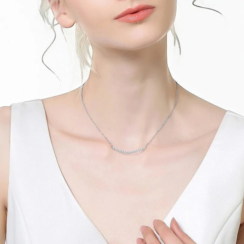 Bee-Bee's 18k gold plated sterling silver necklace with D VVS1 Moissanite stones in a curved smile design.