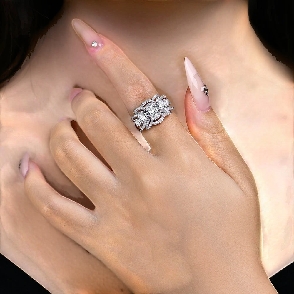 Bee-Bees luxury 1CT round cut moissanite ring in sterling silver worn on a finger with elegant nail art