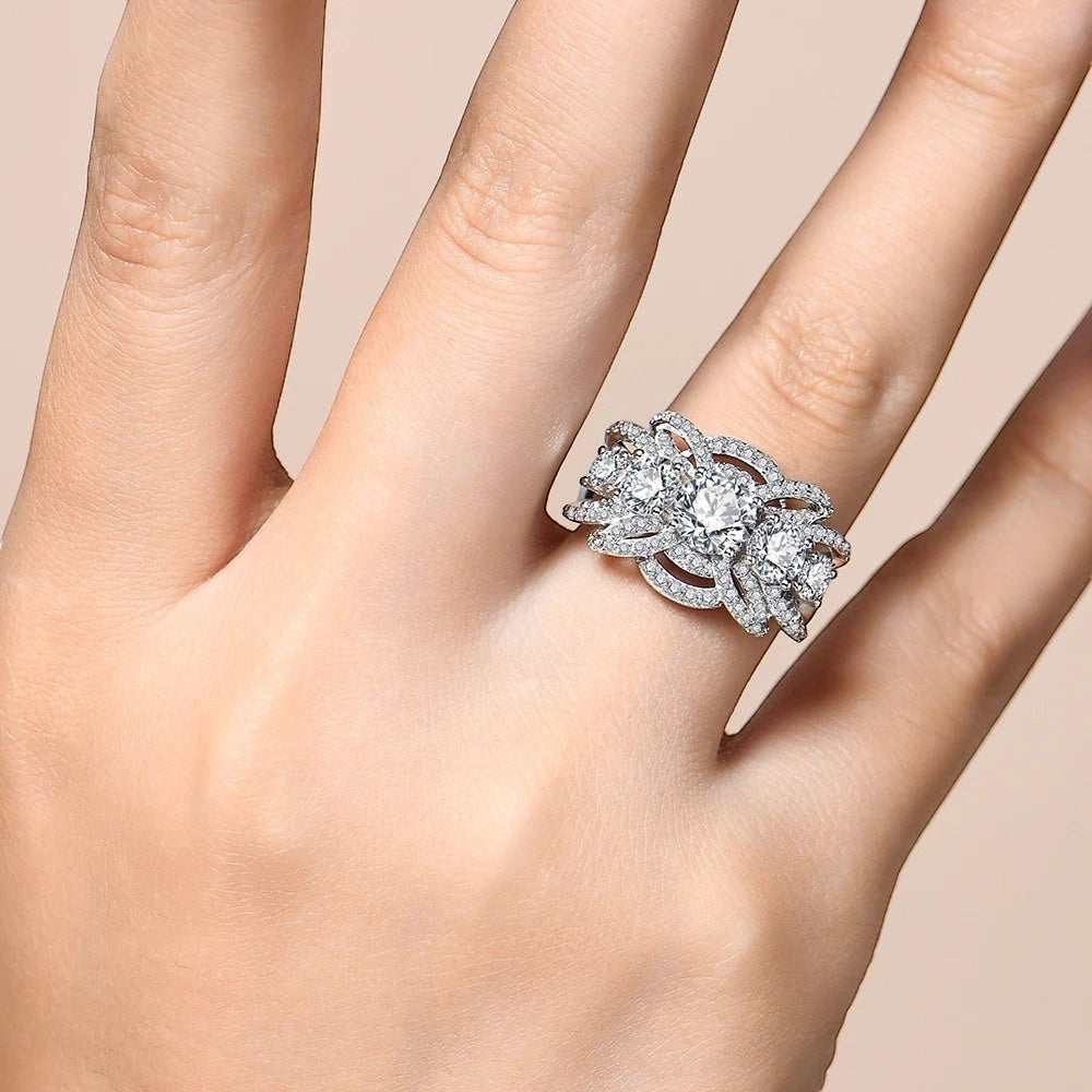 Bee-Bees 1CT round cut moissanite engagement ring in sterling silver with intricate crown-inspired prong setting