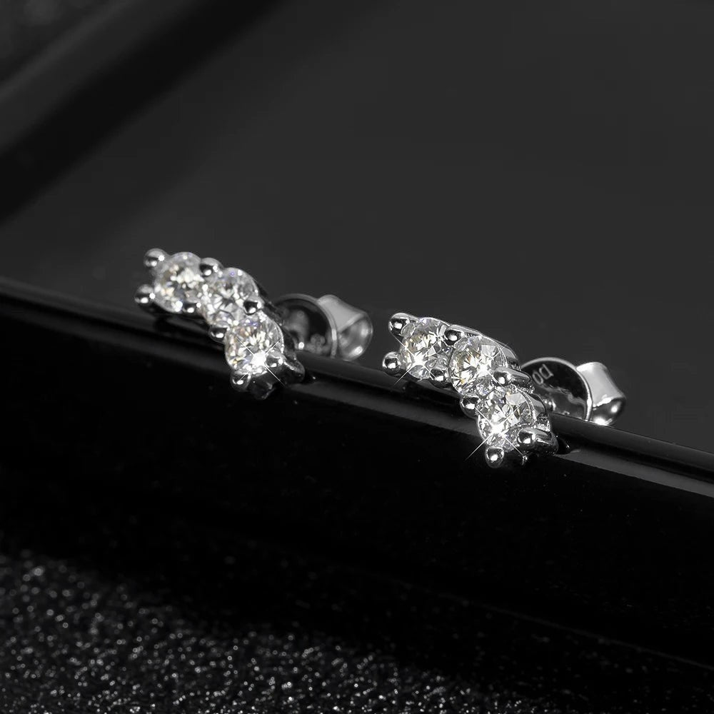 Bee-Bees D Color VVS1 Full Moissanite Studs in 925 Sterling Silver with 18K White Gold plating. Round brilliant cut stones in a 4-prong setting.