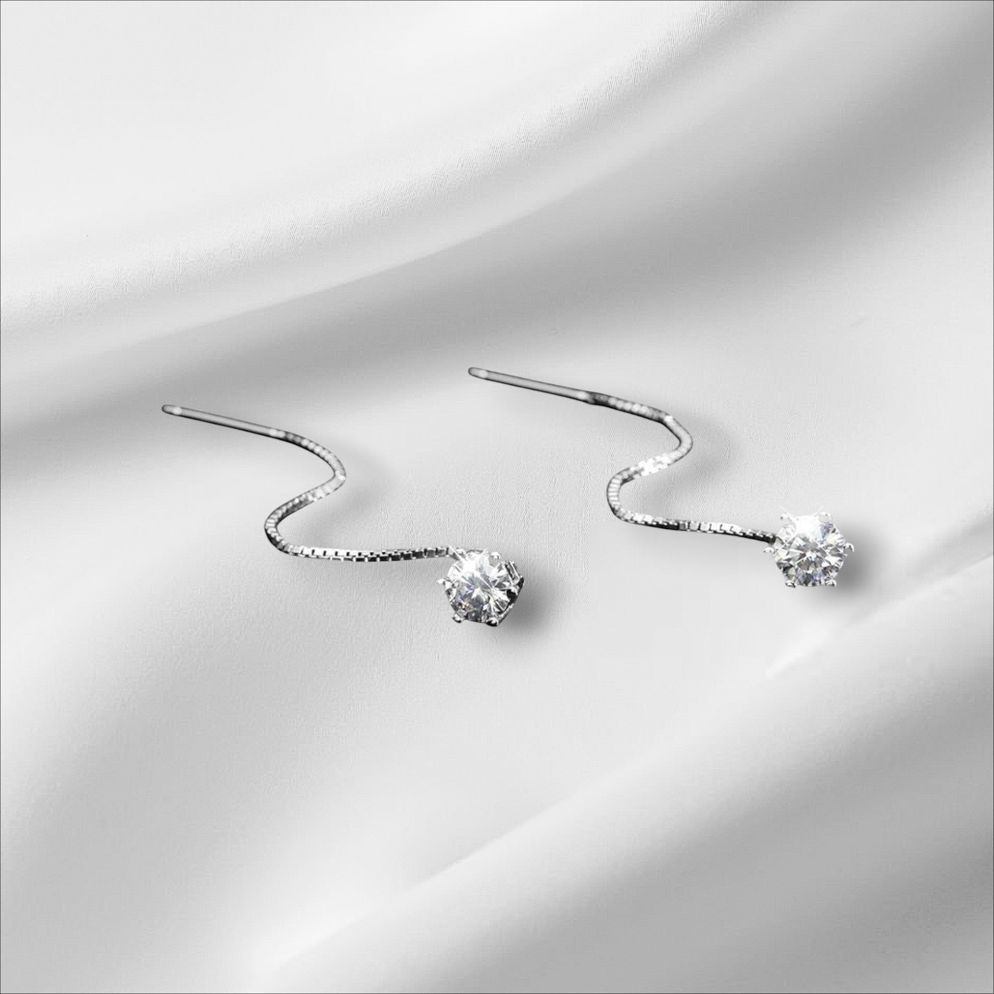 Bee-Bee's D VVS Moissanite stud earrings in S925 sterling silver with 18k white gold plating. Round cut, colorless, VVS clarity.