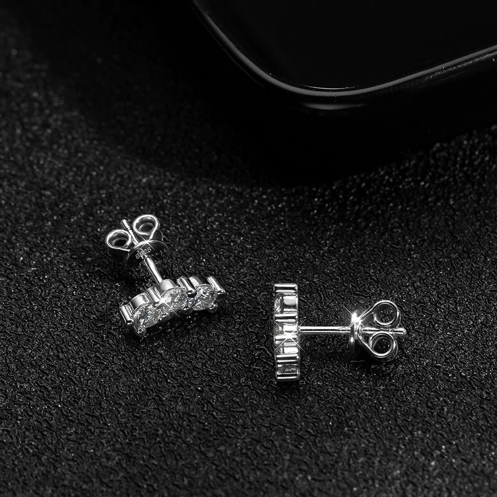 Bee-Bees D Color VVS1 Full Moissanite Studs in 925 Sterling Silver with 18K White Gold plating. Round brilliant cut stones in a 4-prong setting.