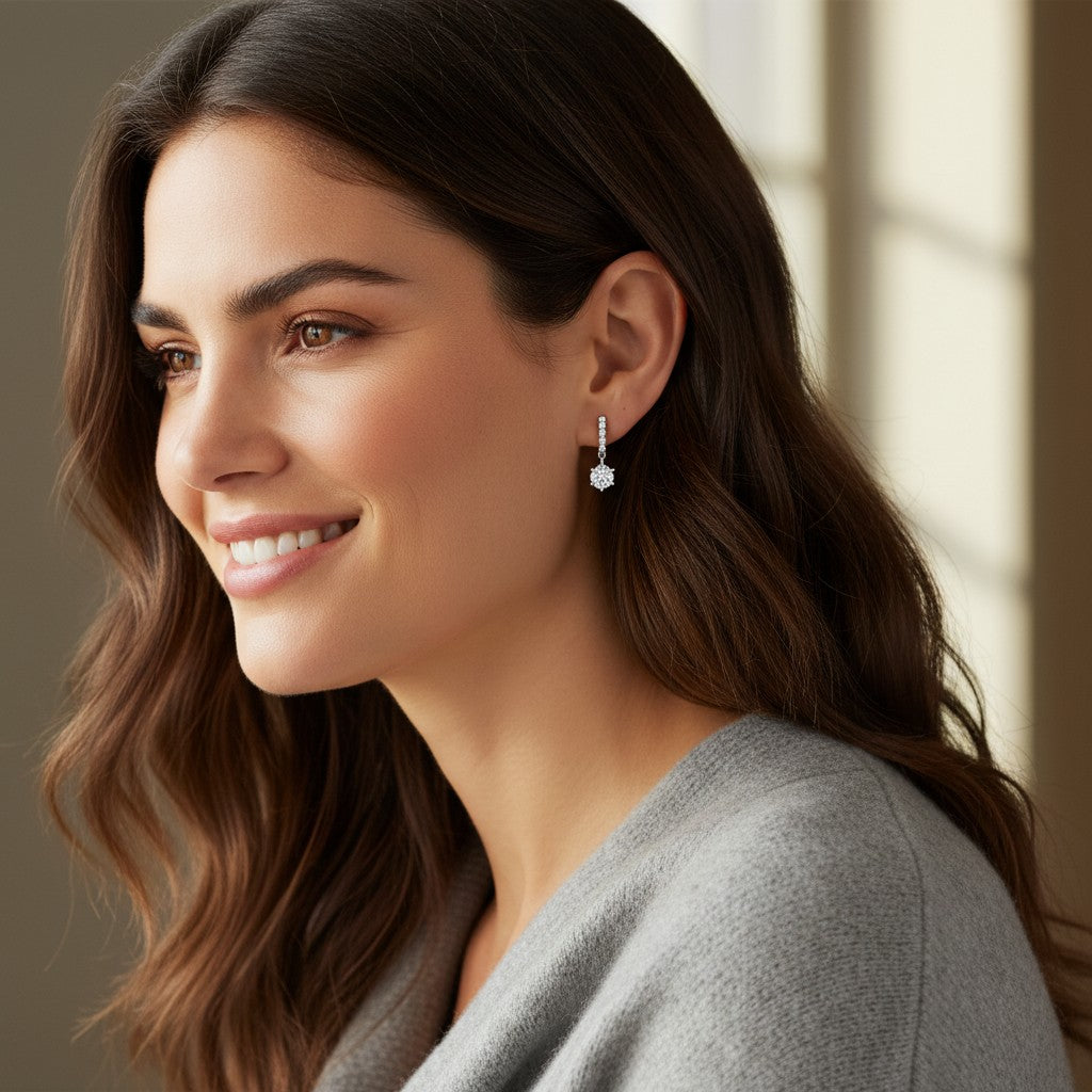 A woman wearing Bee-Bees 1ct D color moissanite stud earrings in 18k white gold plated sterling silver.