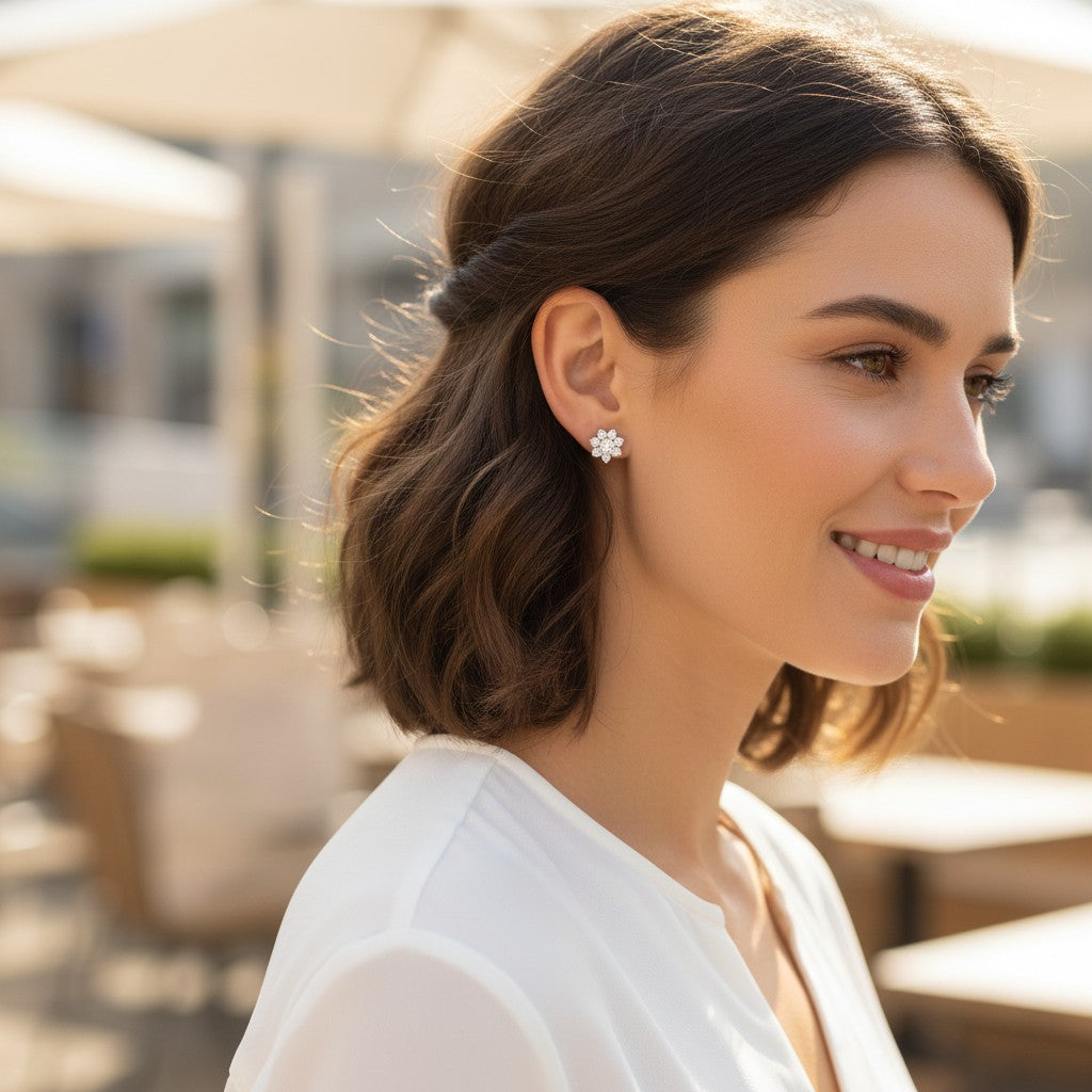 Bee-Bees D VVS1 moissanite stud earrings in 18k white gold plated sterling silver worn by a smiling woman outdoors