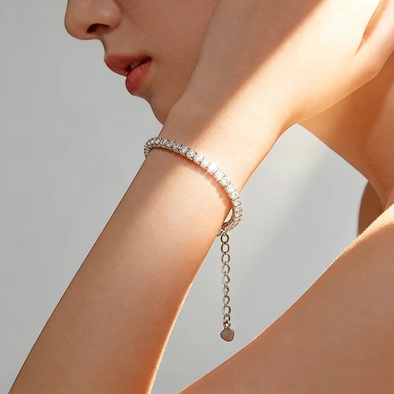 Bee-Bees 1.5mm Moissanite tennis bracelet in sterling silver with adjustable clasp and heart charm.
