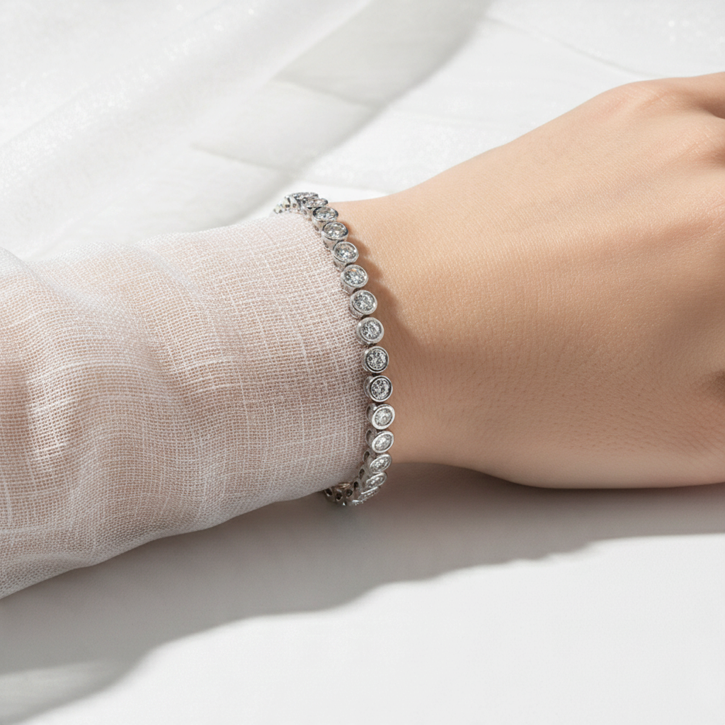 Bee-Bees 3mm round-cut moissanite tennis bracelet in 925 sterling silver worn on a wrist with white fabric sleeve