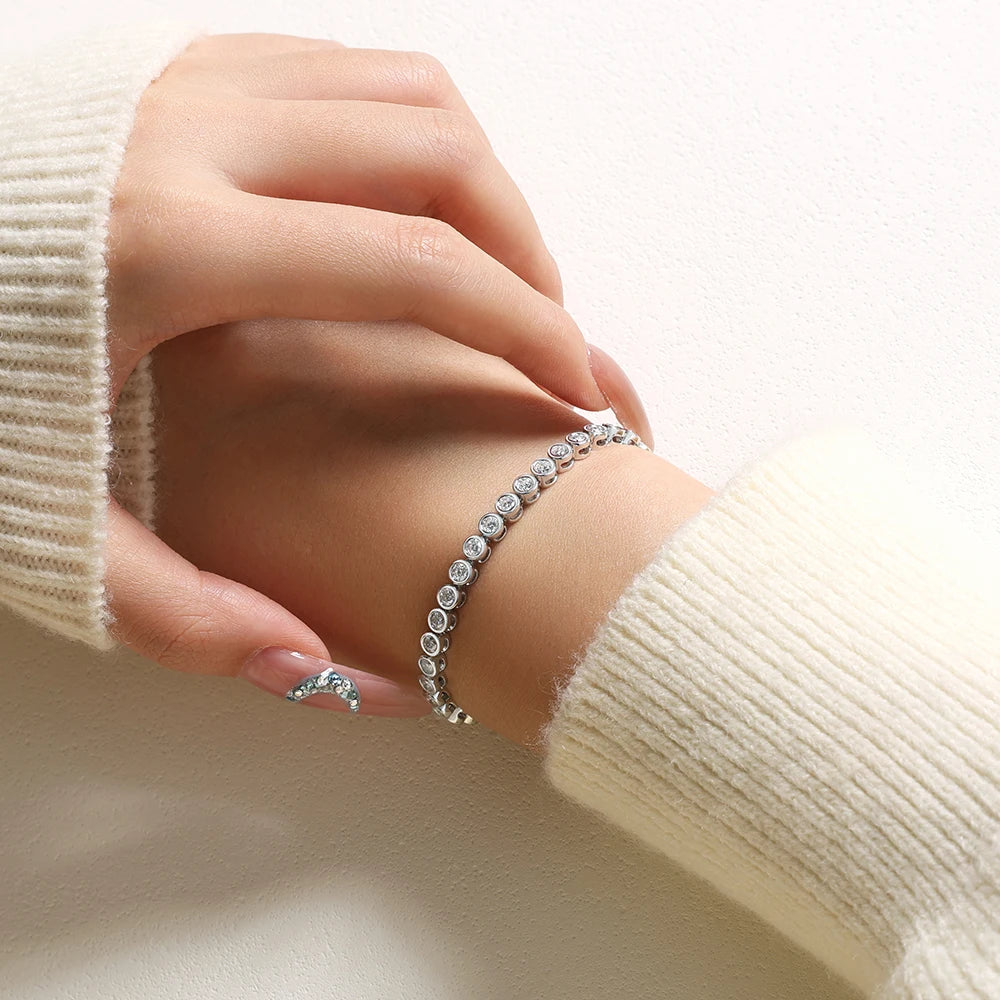 Bee-Bees 3mm round-cut D color VVS1 moissanite tennis bracelet in 925 sterling silver worn on a woman's wrist