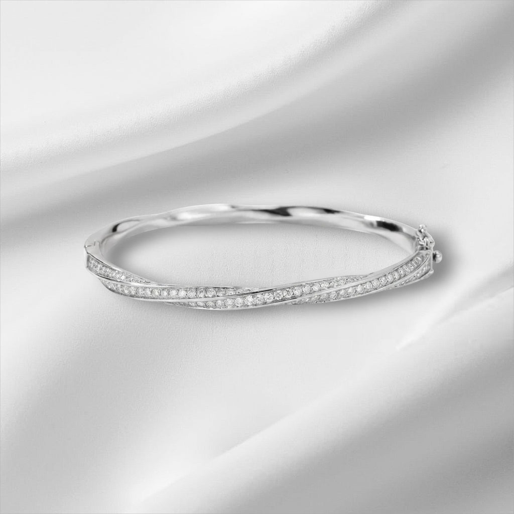 Bee-Bees twisted bangle bracelet with D VVS1 moissanite stones set in 18K gold plated S925 silver.