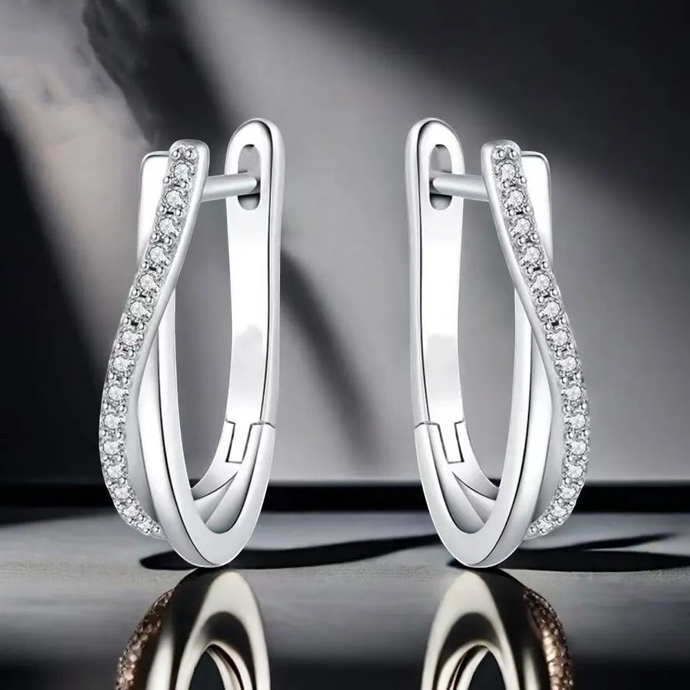 Bee-Bee's sterling silver twisted hoop earrings with pavé-set D Color VVS1 moissanite stones.