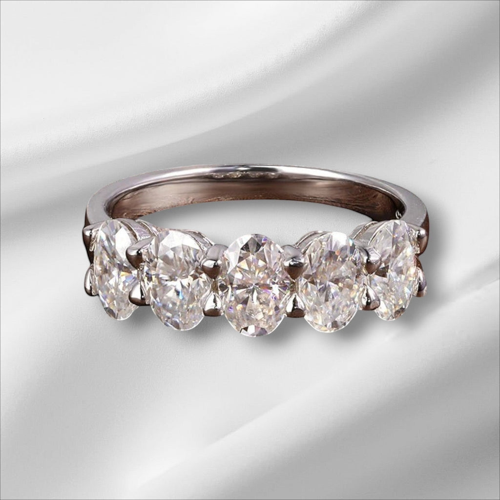 Bee-Bees sterling silver eternity ring with five 4x6mm D Color VVS1 oval moissanite stones.