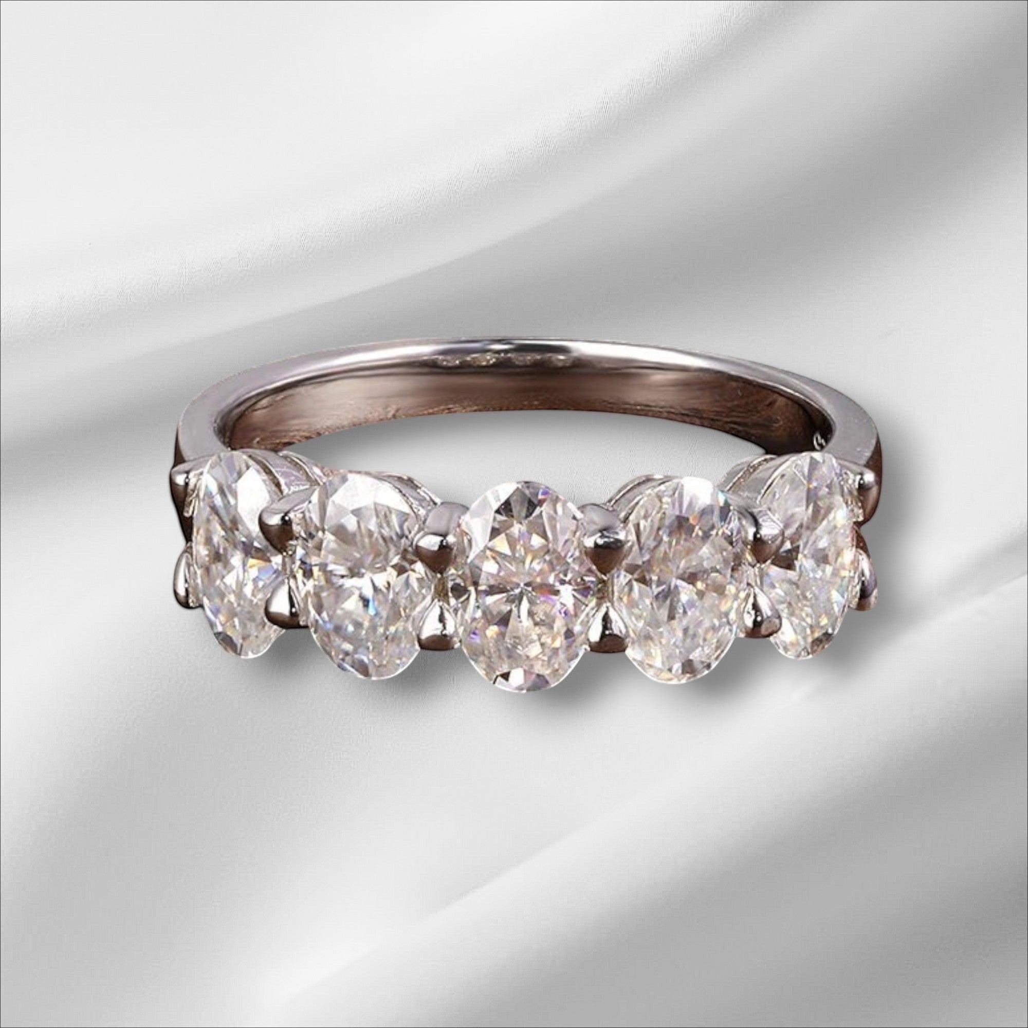 Bee-Bees sterling silver eternity ring with five 4x6mm D Color VVS1 oval moissanite stones.