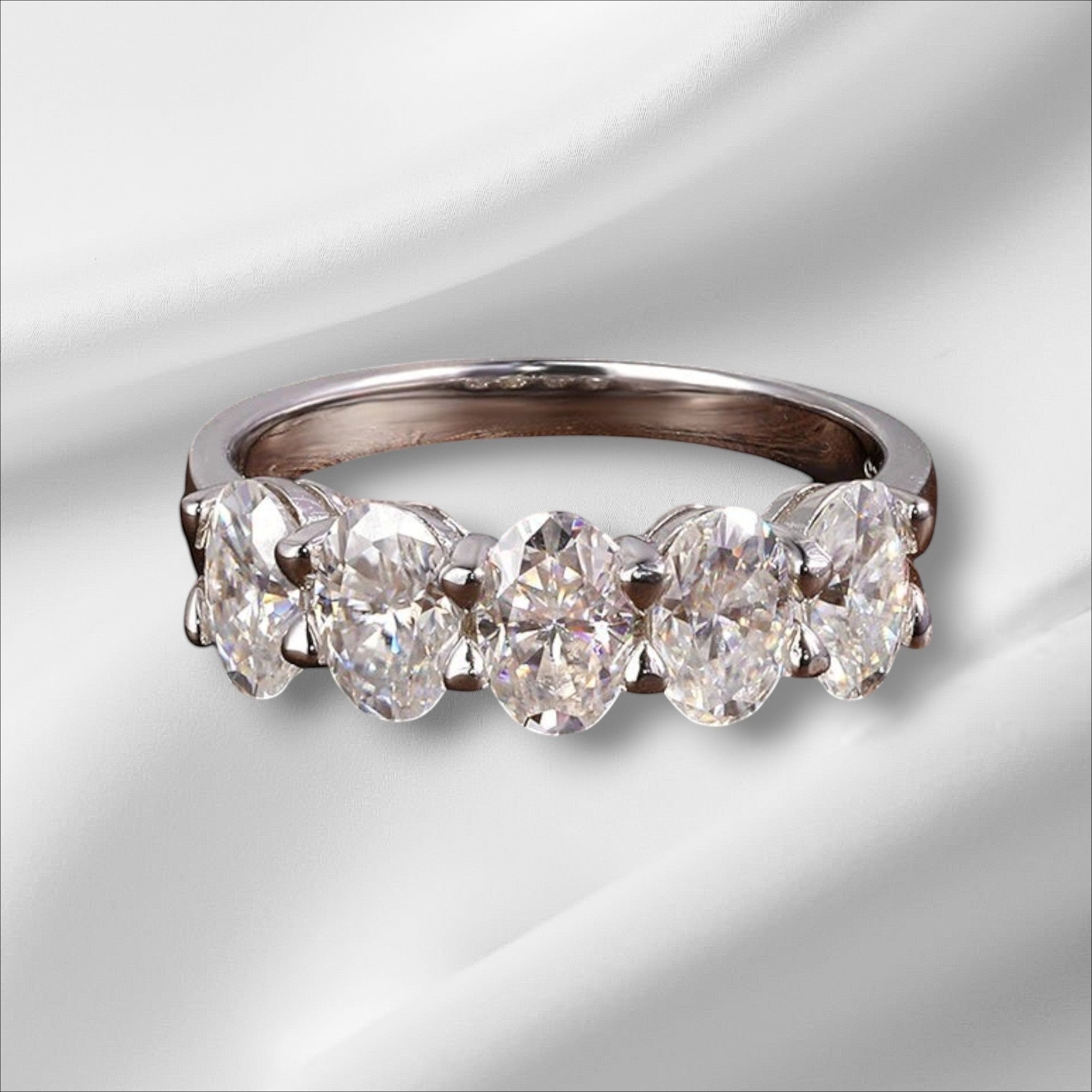 Bee-Bees sterling silver eternity ring with five 4x6mm D Color VVS1 oval moissanite stones.