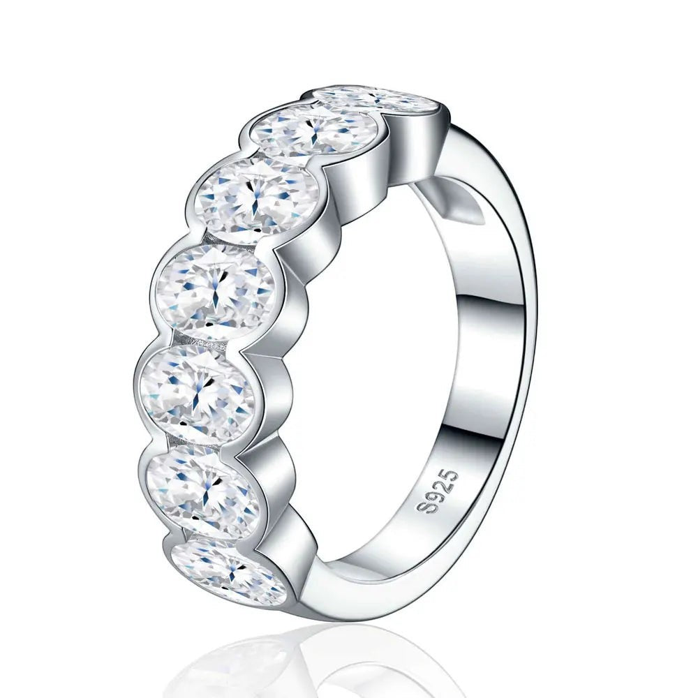Bee-Bees 0.5ct oval-cut moissanite eternity ring in 18k white gold plated sterling silver with shared-prong setting.