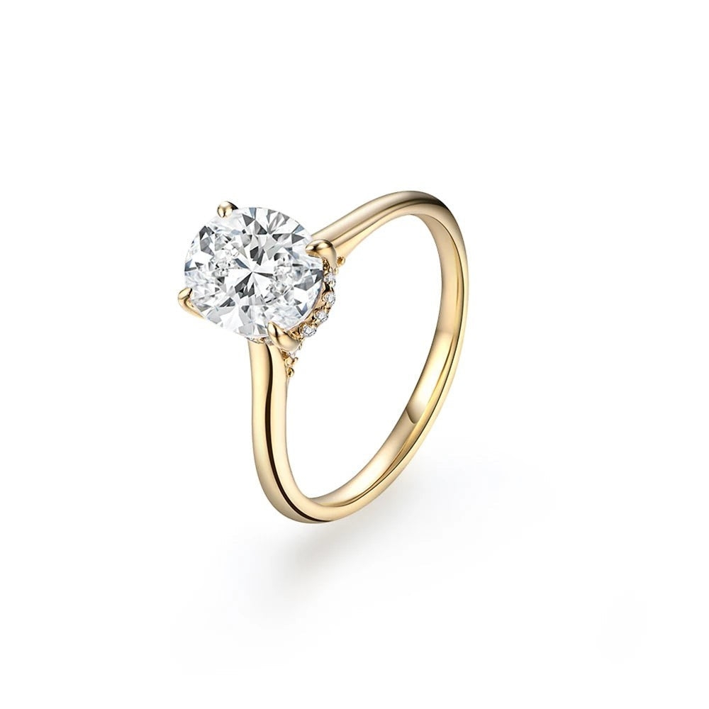 Bee-Bees 2CT oval moissanite engagement ring in yellow gold with a classic four-prong setting and brilliant center stone.