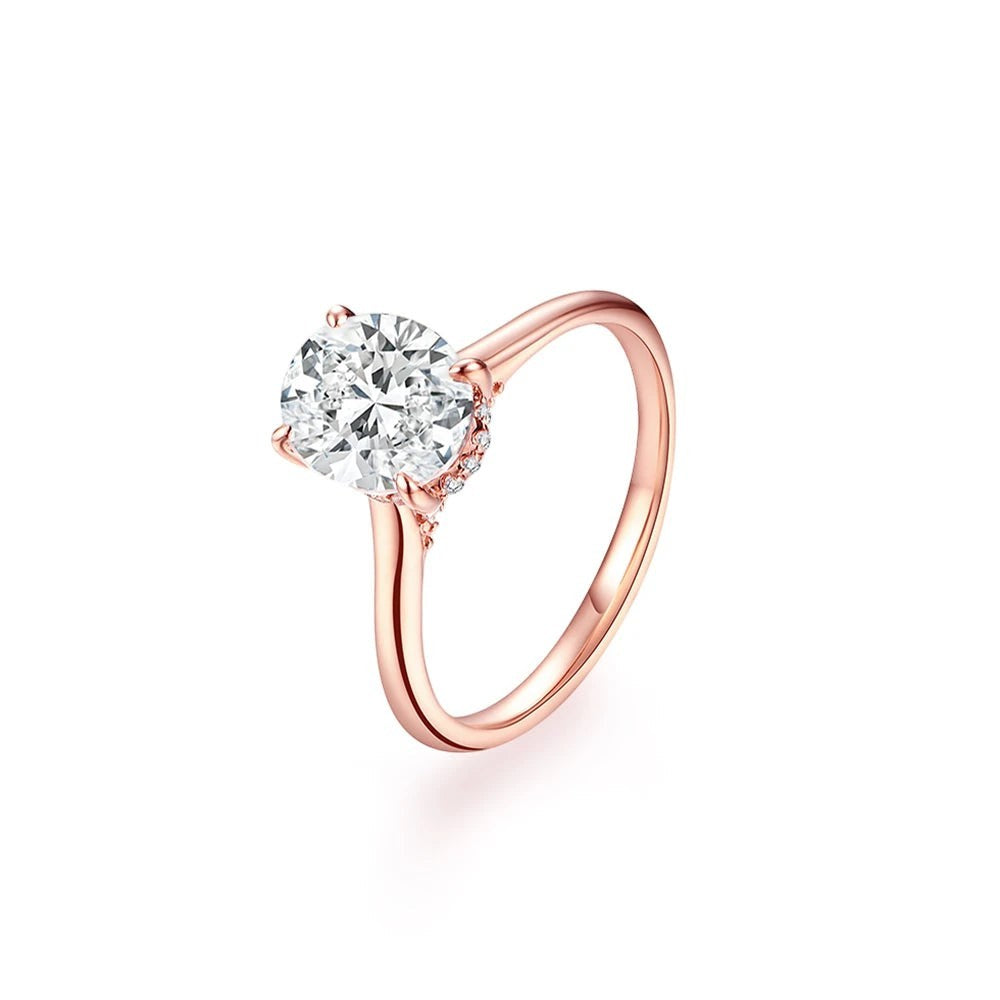 Bee-Bees 2CT oval-cut moissanite engagement ring in rose gold with a classic four-prong setting and delicate side stones.
