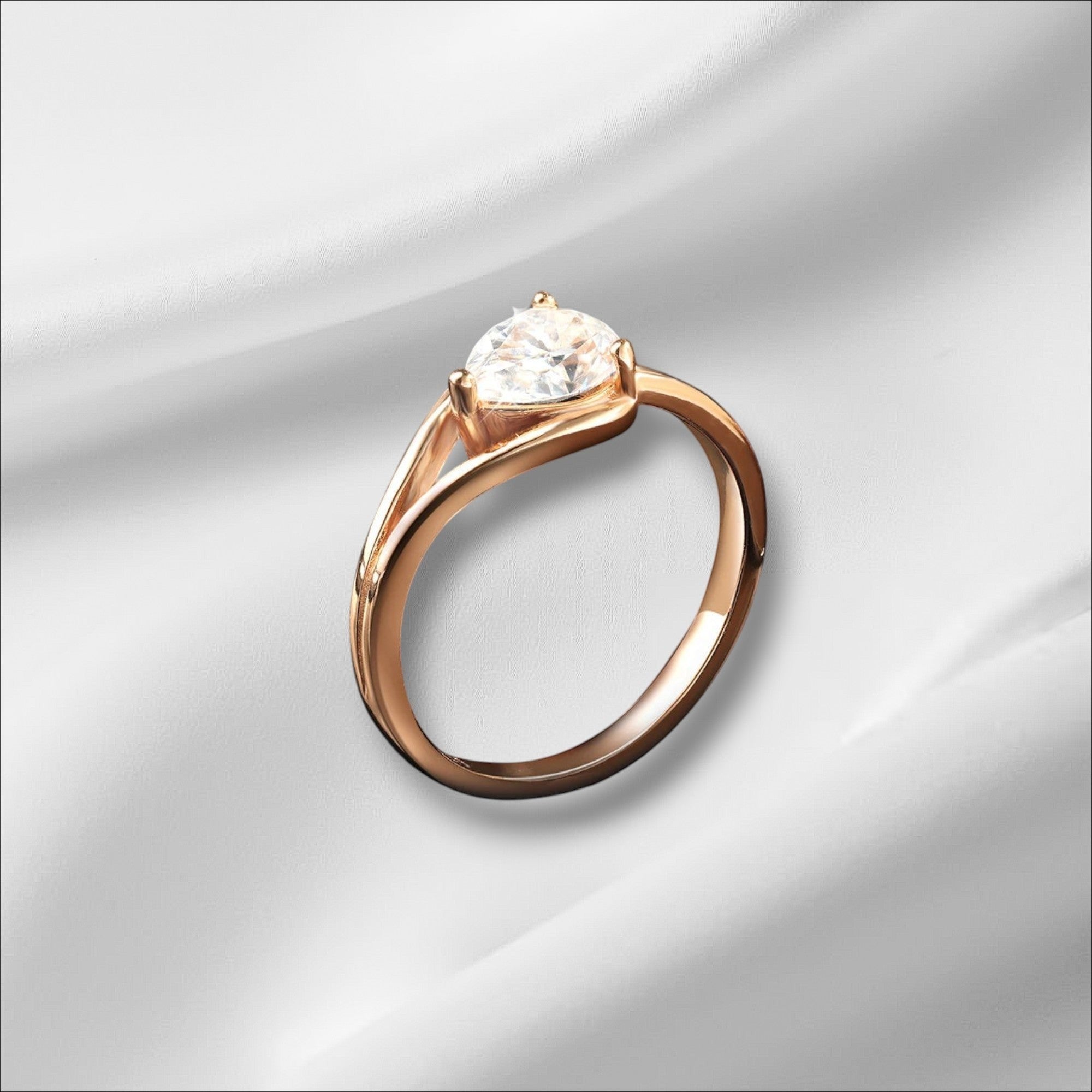 Bee-Bees 1ct pear cut moissanite engagement ring in rose gold plated sterling silver with GRA certification.