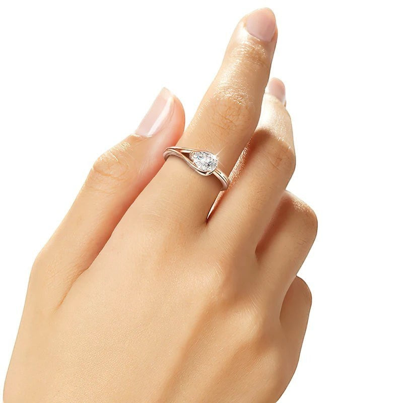 Bee-Bees 1ct pear cut moissanite engagement ring in rose gold plated sterling silver with a solitaire stone.