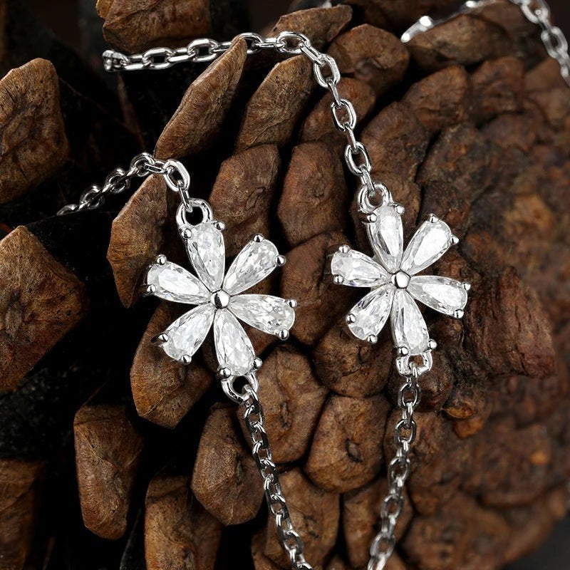Bee-Bees Sterling silver necklace with flower pendant featuring pear cut moissanite stones. Dainty and elegant.