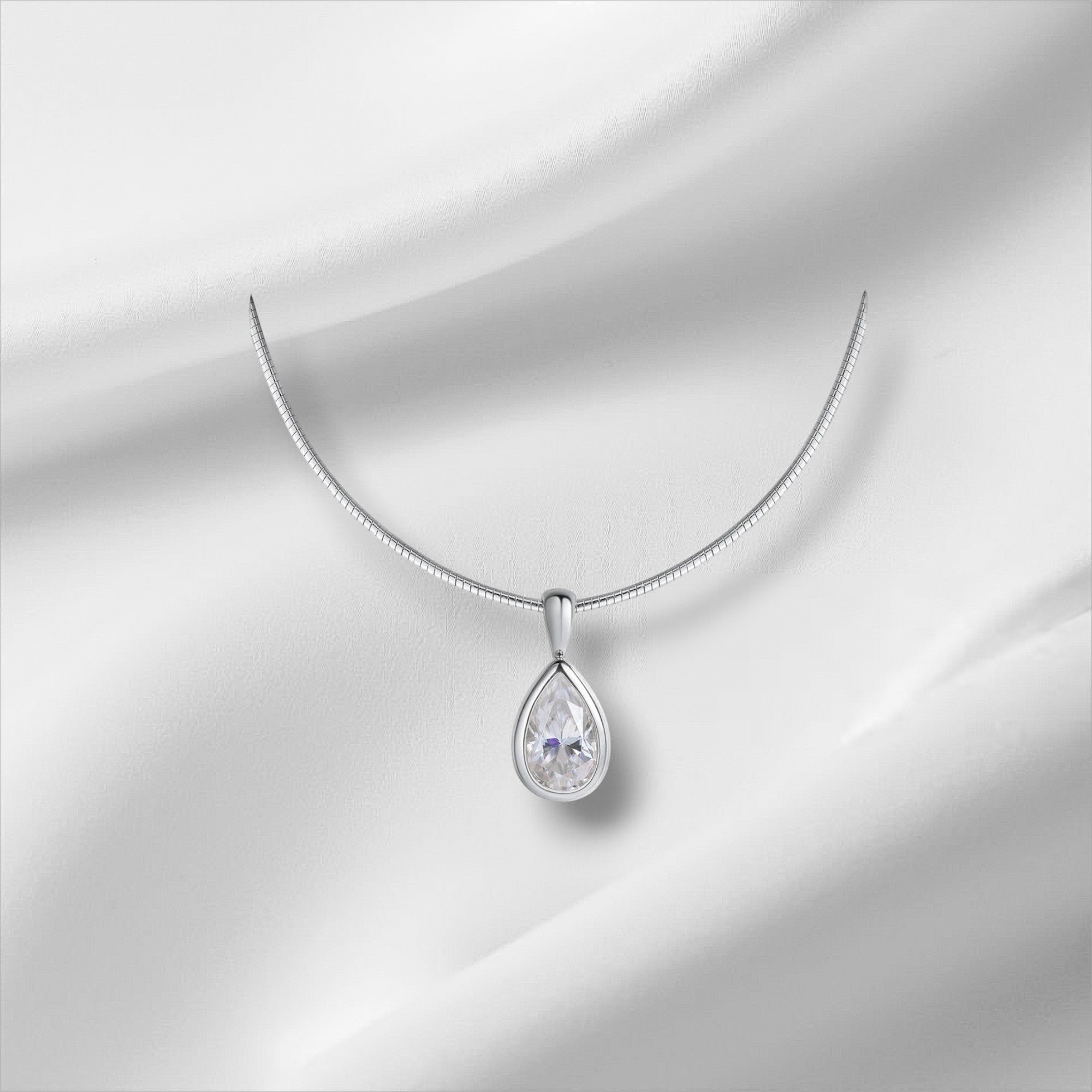Bee-Bee's 3ct pear cut moissanite pendant necklace with D Color VVS1 clarity on an 18k gold plated sterling silver chain.