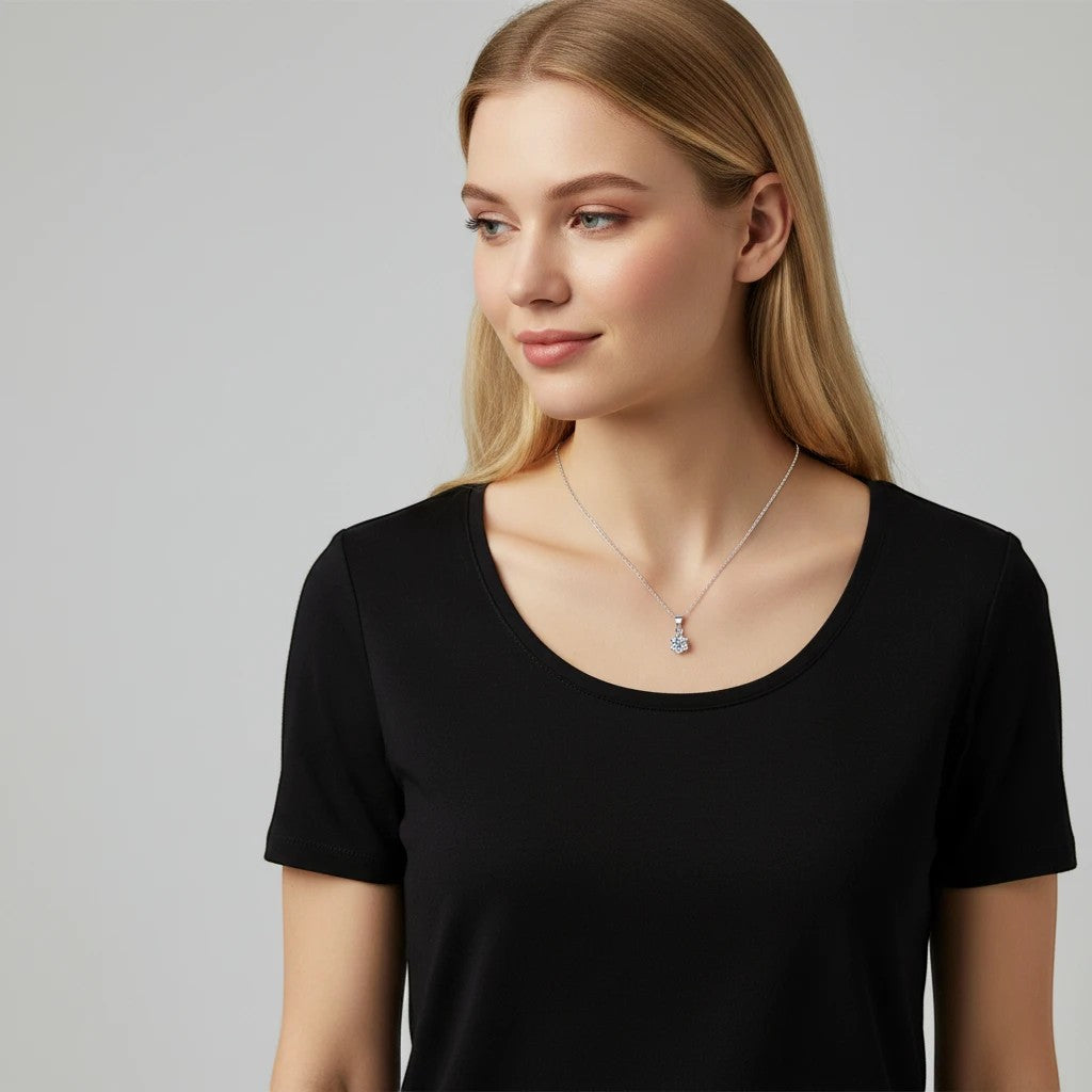 Bee-Bee's classic pear cut moissanite necklace in S925 silver with a delicate chain, worn by a blonde model.