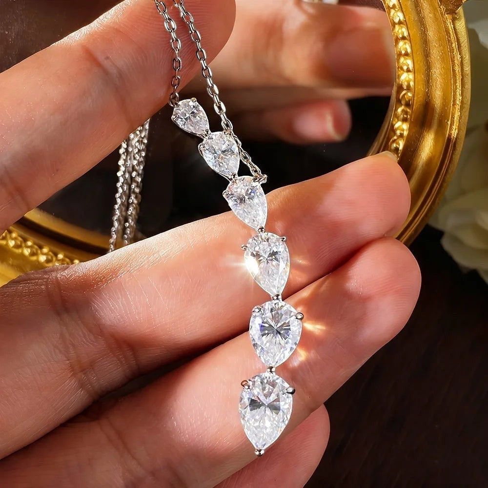 Bee-Bee's 7.6ct pear cut moissanite necklace with five teardrop stones on a silver chain.