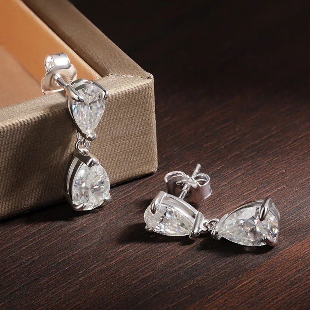 Bee-Bee's D VVS1 Pear Cut Moissanite Drop Earrings in S925 Sterling Silver with 18k Gold plating. Features two clear, sparkling pear-shaped stones.
