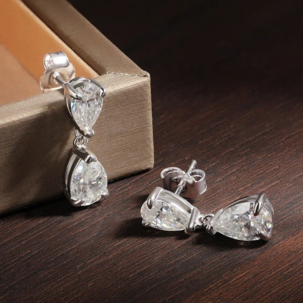 Bee-Bee's D VVS1 Pear Cut Moissanite Drop Earrings in S925 Sterling Silver with 18k Gold plating. Features two clear, sparkling pear-shaped stones.