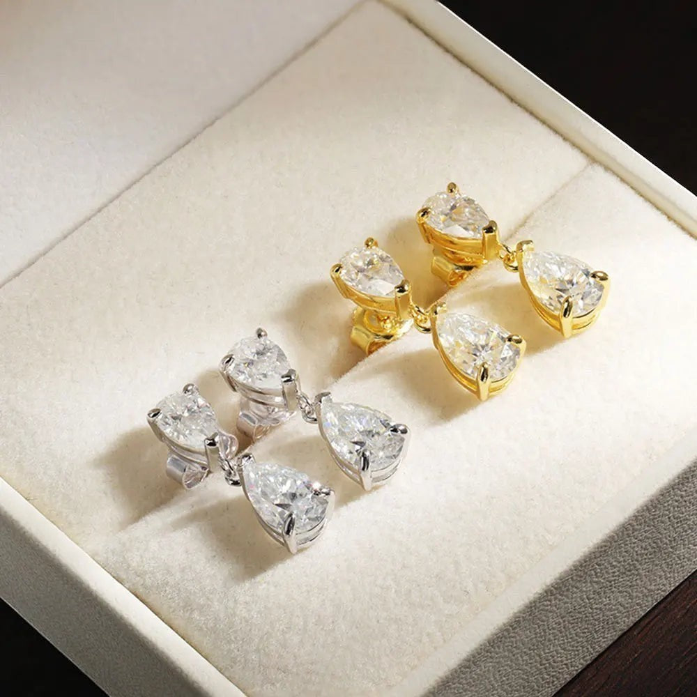 Bee-Bee's D VVS1 pear cut moissanite drop earrings in silver and gold plating. GRA certified.