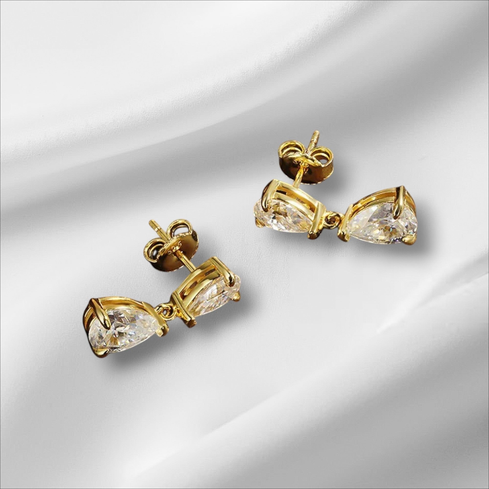 Bee-Bees D VVS1 pear cut moissanite drop earrings in 18k gold plated sterling silver with secure stud backing.