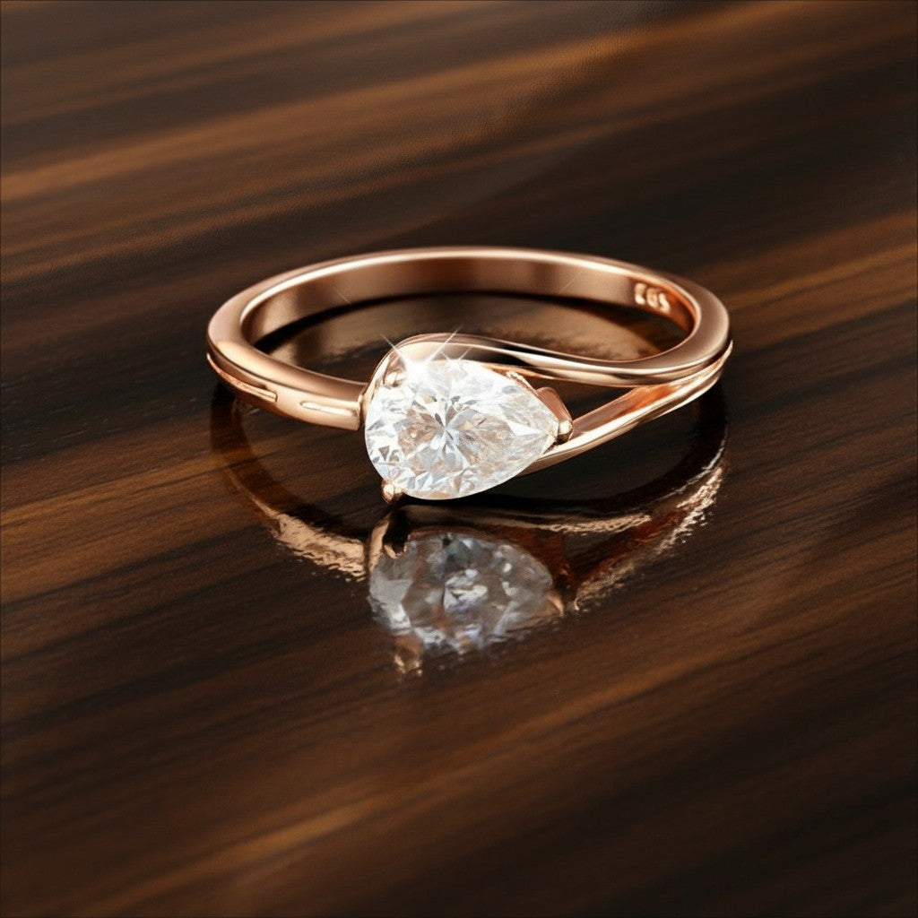 Bee-Bees 1ct pear cut moissanite engagement ring in rose gold plated sterling silver with GRA certification.