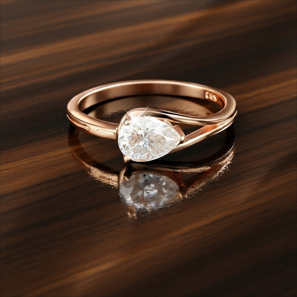 Bee-Bees 1ct pear cut moissanite engagement ring in rose gold plated sterling silver with GRA certification.