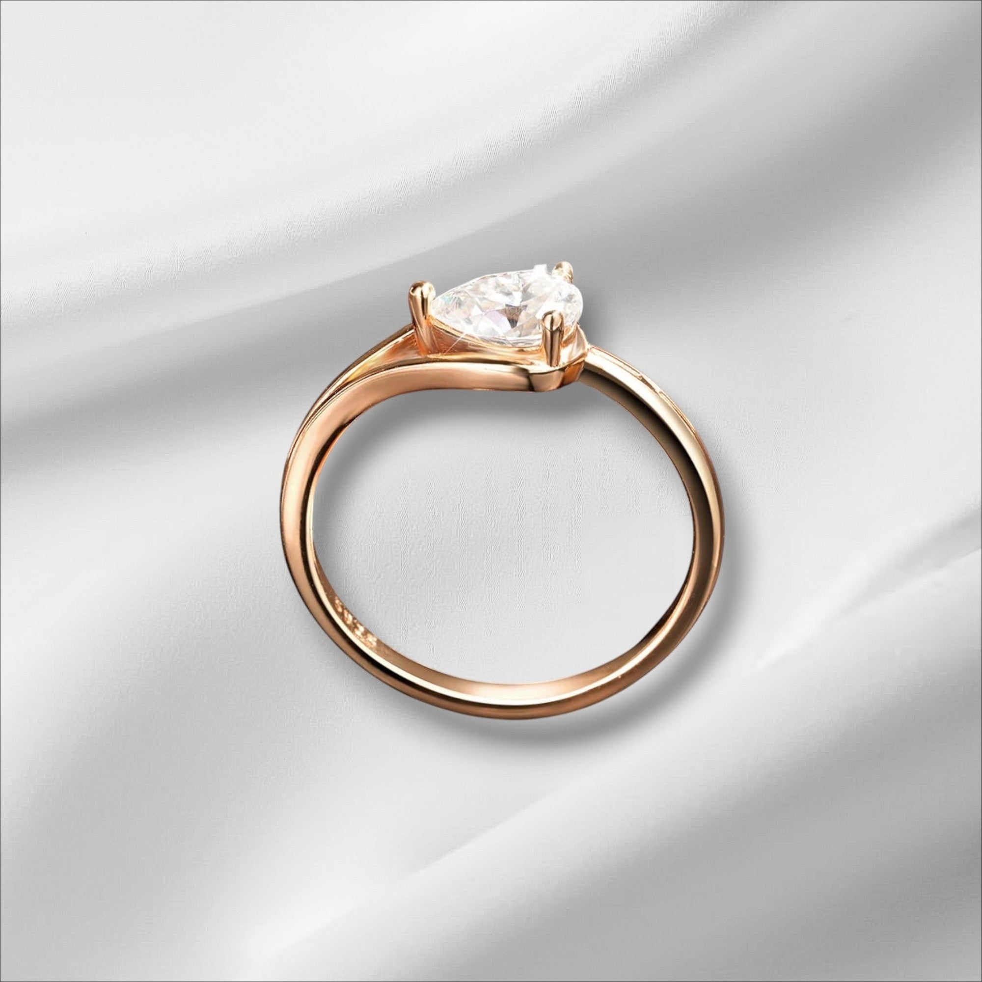 Bee-Bees 1ct pear cut moissanite engagement ring in rose gold plated sterling silver with GRA certification.