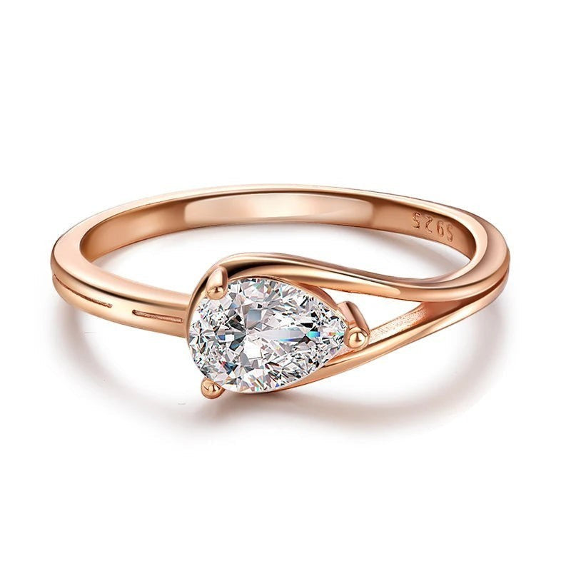 Bee-Bees 1ct pear cut moissanite engagement ring in rose gold plated sterling silver with GRA certification.
